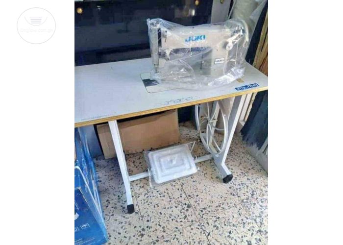 BRAND NEW SEWING MACHINE WITH TABLE AND ALL ACCESSORIES. 
